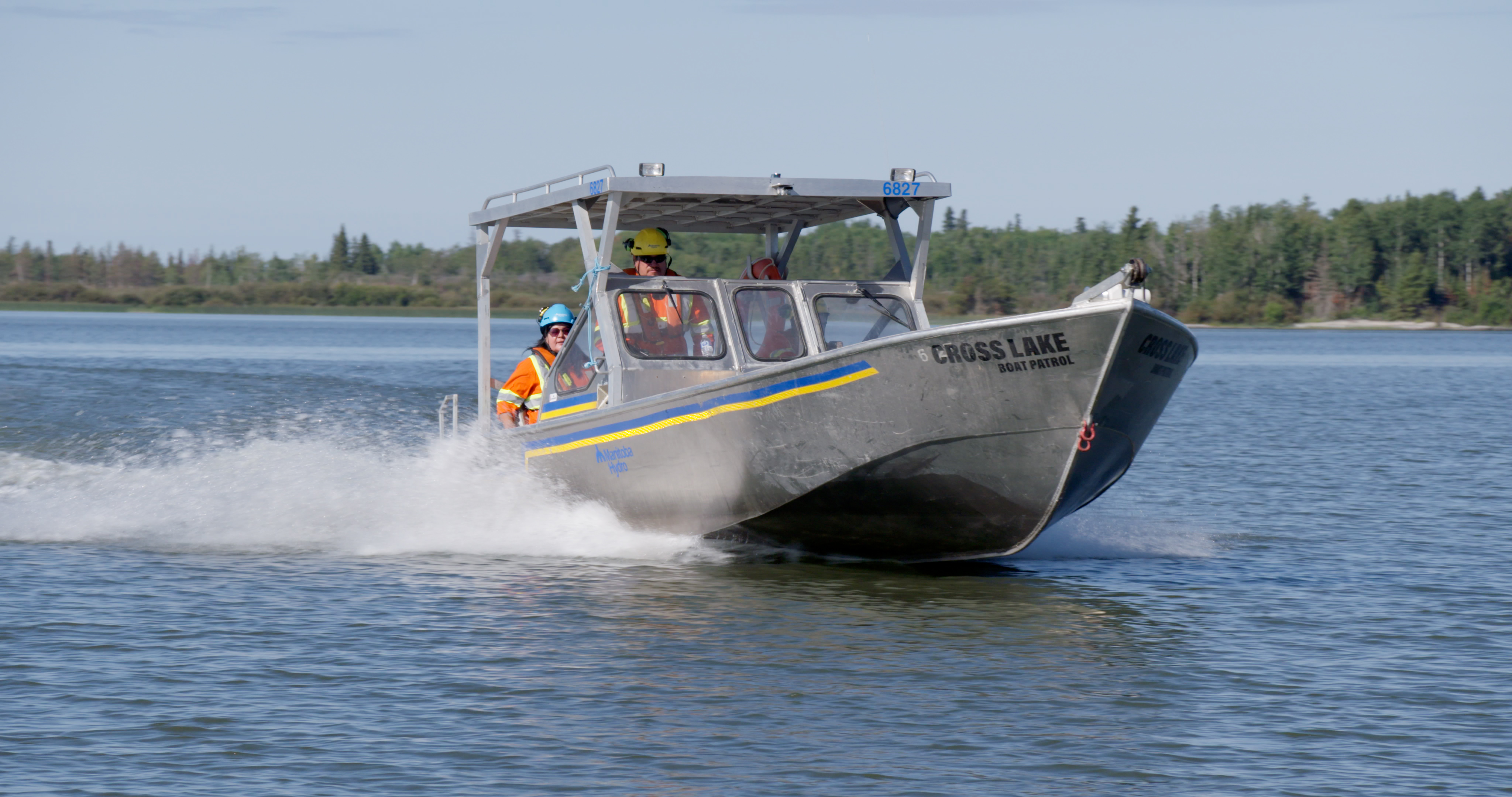 Manitoba Hydro employees on a boat on Cross Lake.