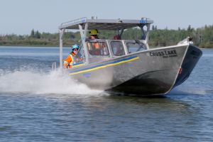 Manitoba Hydro employees on a boat on Cross Lake.