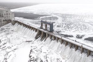 Arial photo of a generating station in winter with snow and ice.