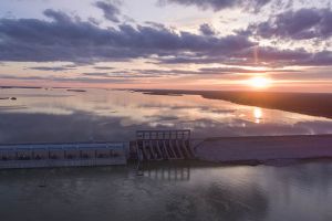 Arial photo of a hydroelectric generating station at sunset.